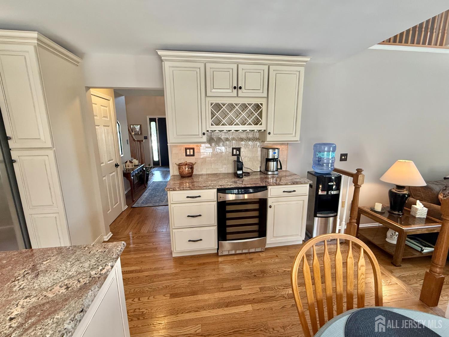 44 Diamond Lane Howell, NJ 07731 - Photo 8 of 35 a kitchen with stainless steel appliances granite countertop a stove a refrigerator and a dining table with wooden floor