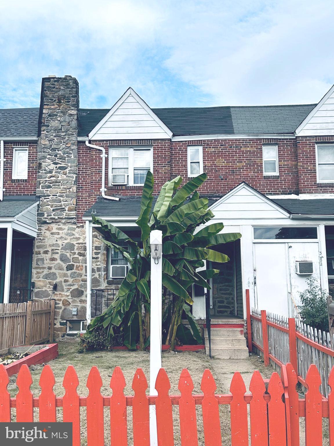 a front view of house with a garden