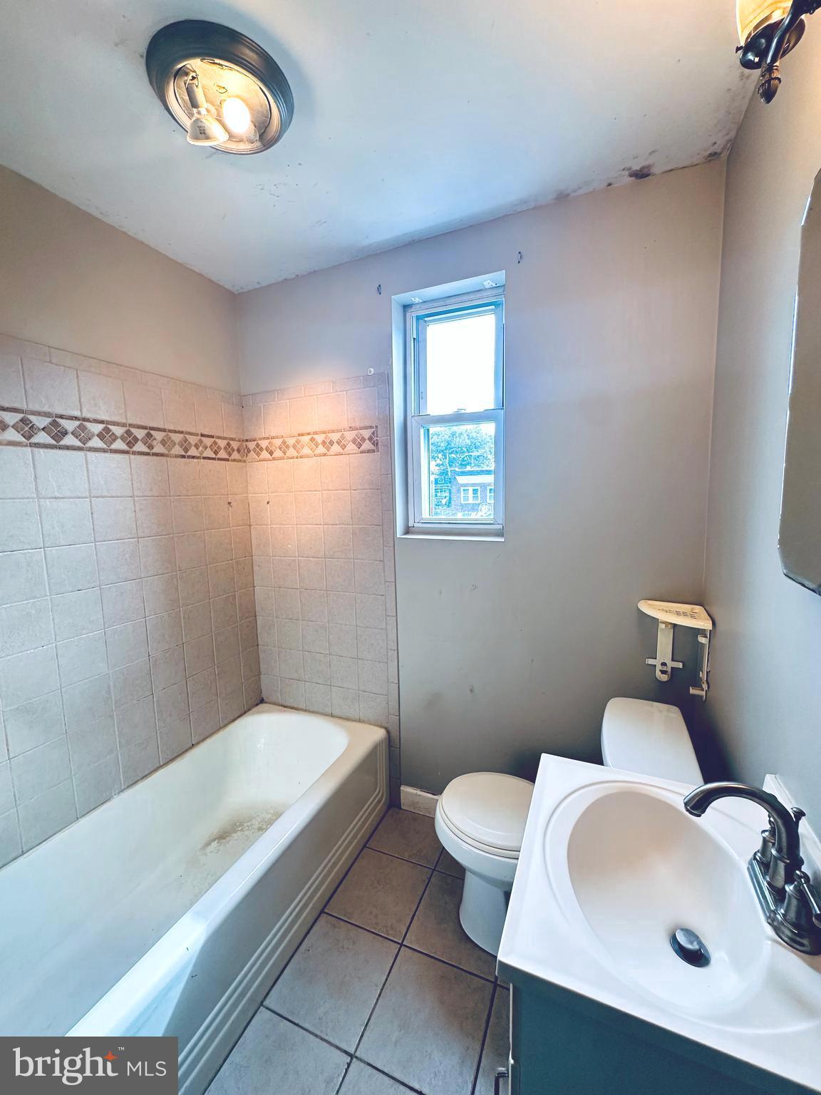 3804 Brooklyn Avenue Baltimore, MD 21225 - Photo 14 of 26 a bathroom with a sink a toilet and a tub