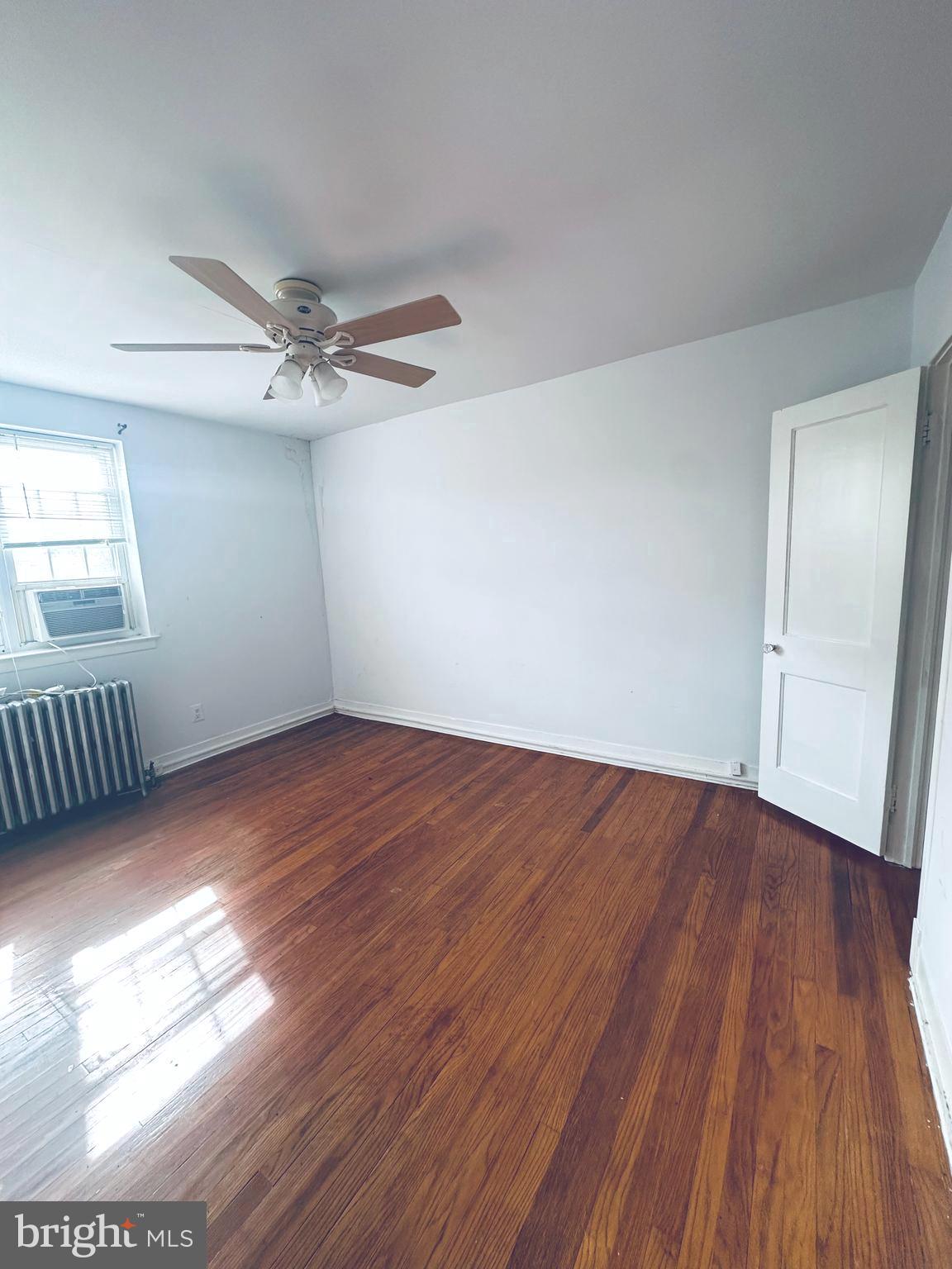 3804 Brooklyn Avenue Baltimore, MD 21225 - Photo 20 of 26 wooden floor in an empty room with a window