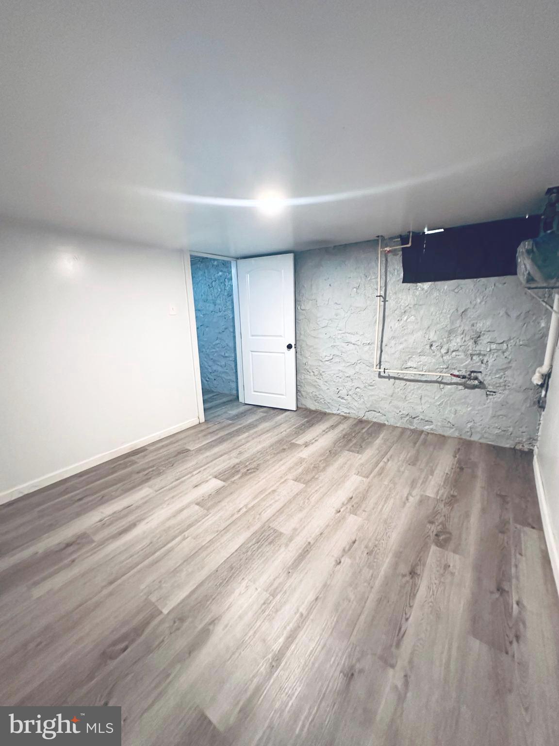 3804 Brooklyn Avenue Baltimore, MD 21225 - Photo 23 of 26 a view of empty room with wooden floor