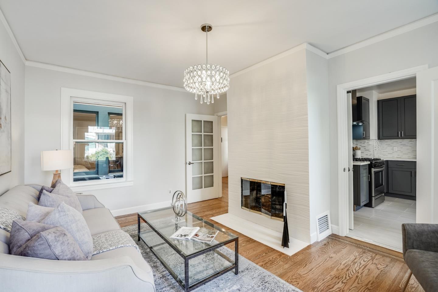 31-33 Boardman Place San Francisco, CA 94103 - Photo 12 of 35 a living room with furniture chandelier and a fireplace