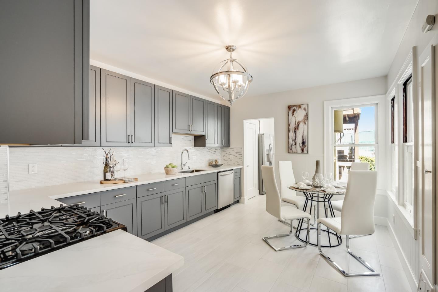 31-33 Boardman Place San Francisco, CA 94103 - Photo 14 of 35 a kitchen with a table chairs stove and cabinets