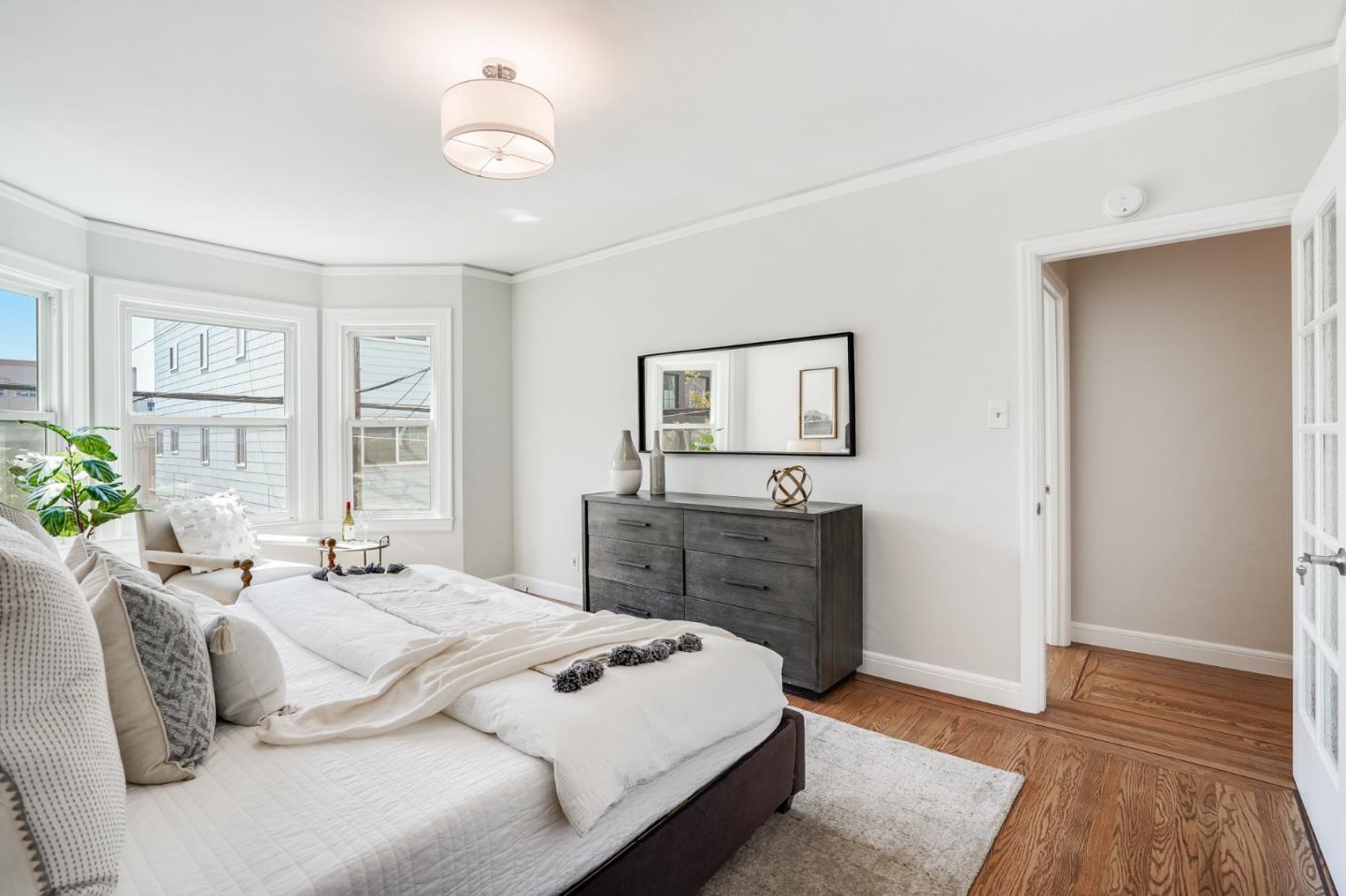 31-33 Boardman Place San Francisco, CA 94103 - Photo 23 of 35 a bedroom with a bed and wooden floor