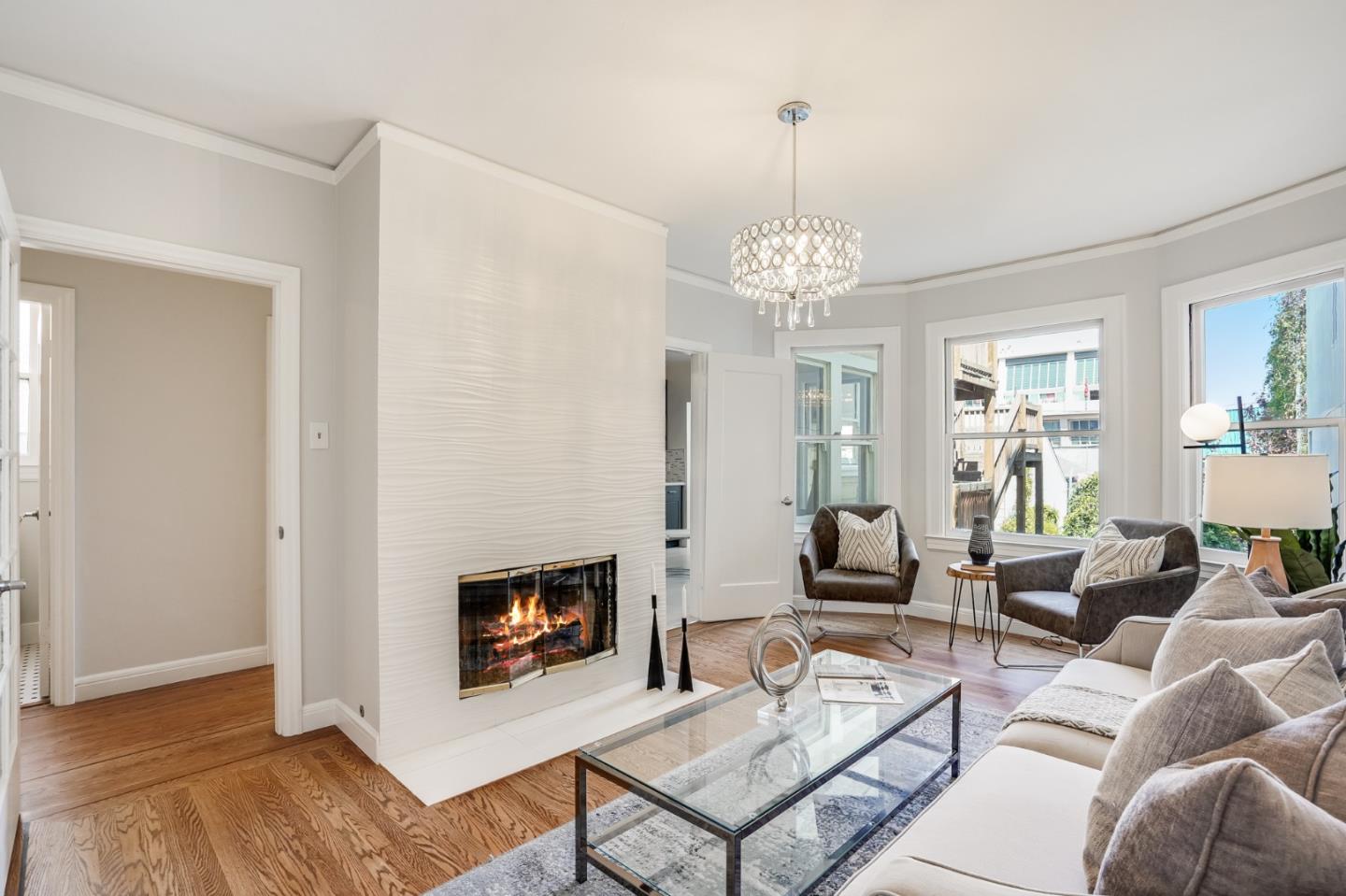 31-33 Boardman Place San Francisco, CA 94103 - Photo 9 of 35 a living room with furniture a chandelier and a fireplace