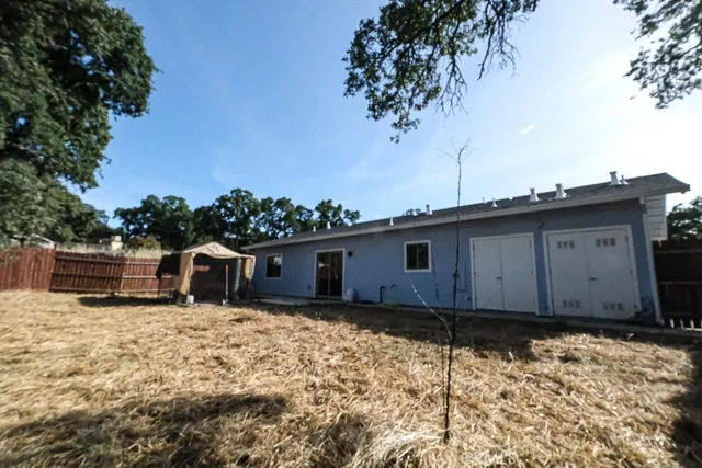 a view of a house with wooden fence