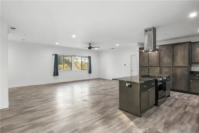 an empty room with wooden floor and window