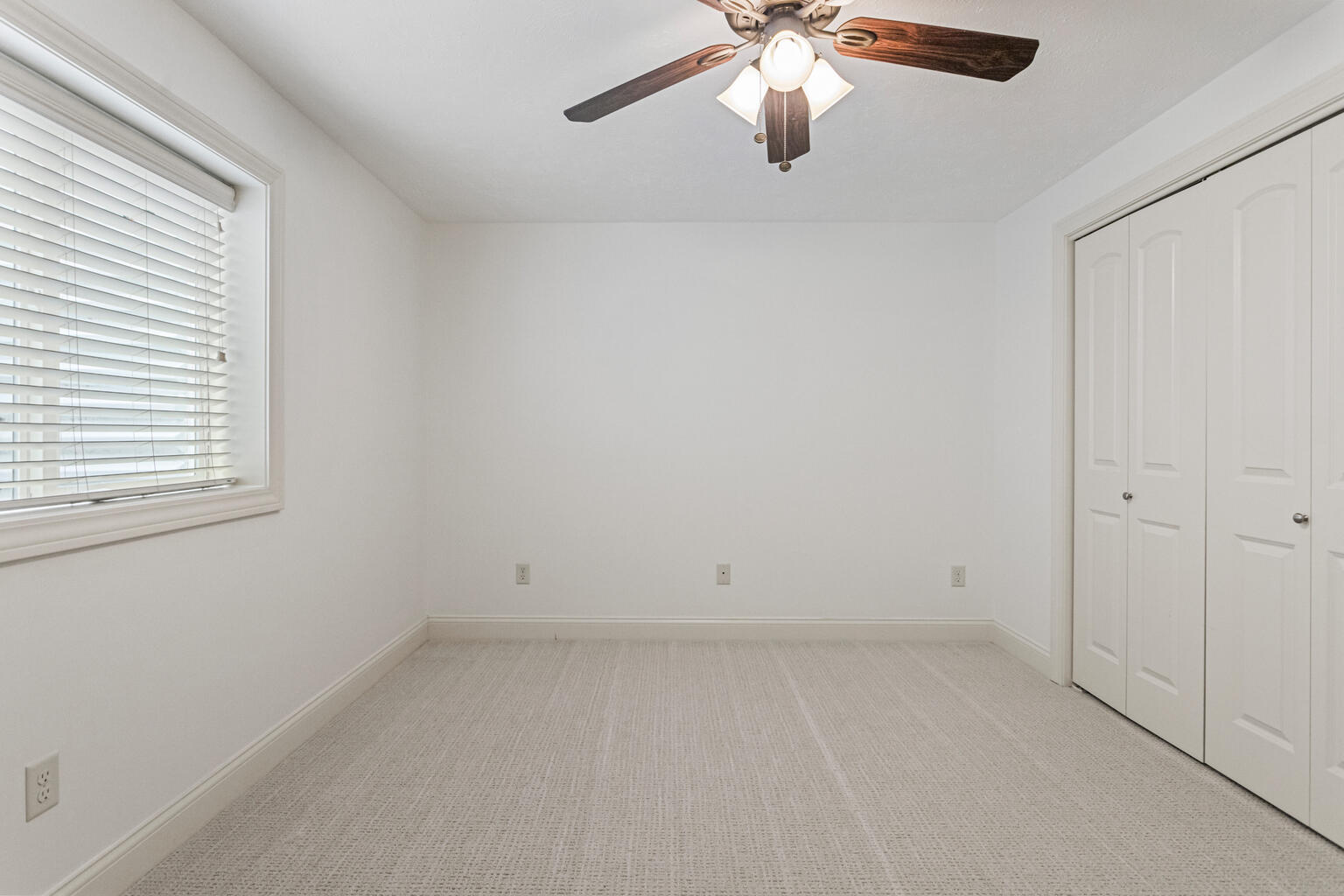 5102 Jacks Boulevard Champaign, IL 61822 - Photo 34 of 40 an empty room with a window and a fan