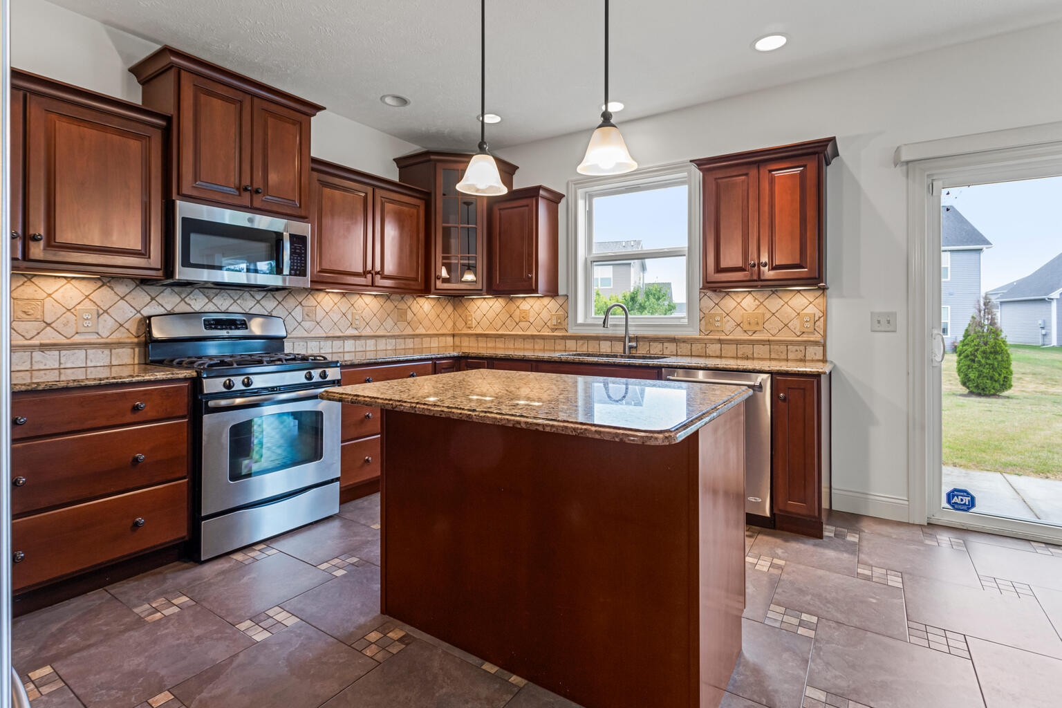 5102 Jacks Boulevard Champaign, IL 61822 - Photo 10 of 40 a kitchen with stainless steel appliances granite countertop a sink a stove and a refrigerator