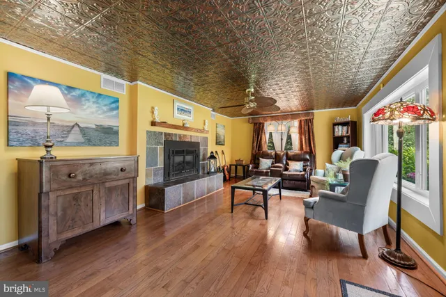 a living room with furniture a fireplace and a flat screen tv