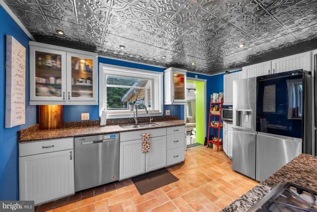 a kitchen with lots of counter top space and stainless steel appliances