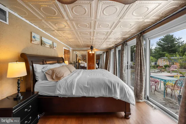 a bedroom with a large bed and a chandelier