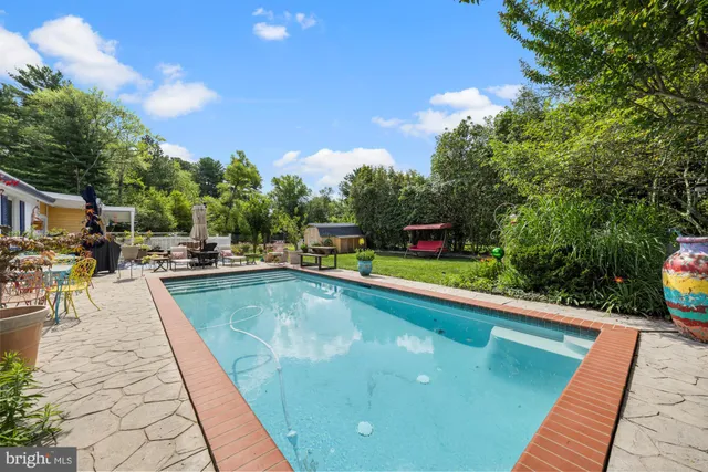 a view of swimming pool with chairs