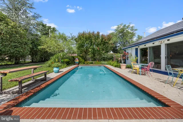 a view of a backyard with a slide and wooden fence