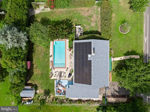 a view of a house with backyard swimming pool and sitting area