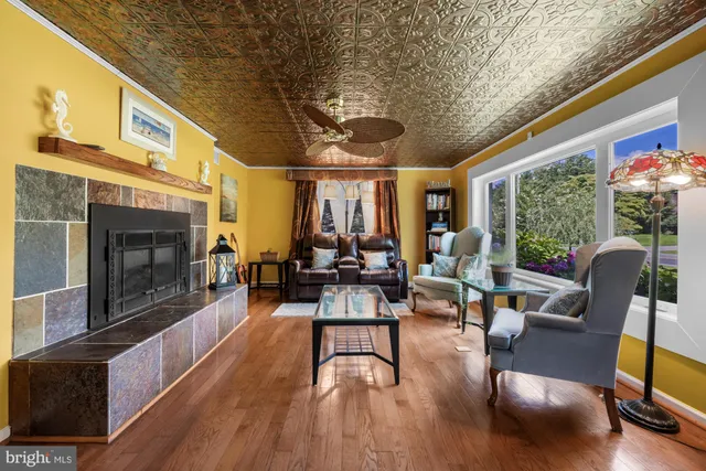 a living room with furniture fireplace and floor to ceiling window