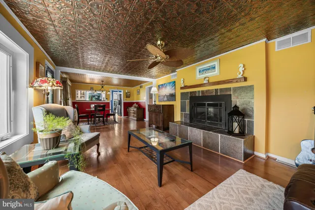 a living room with furniture a flat screen tv and a table