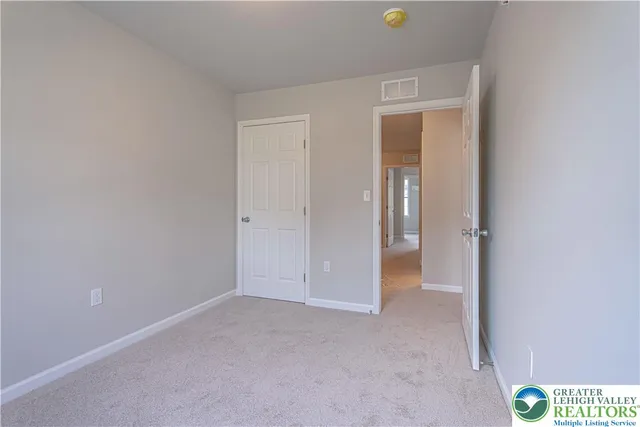 a view of an empty room and closet