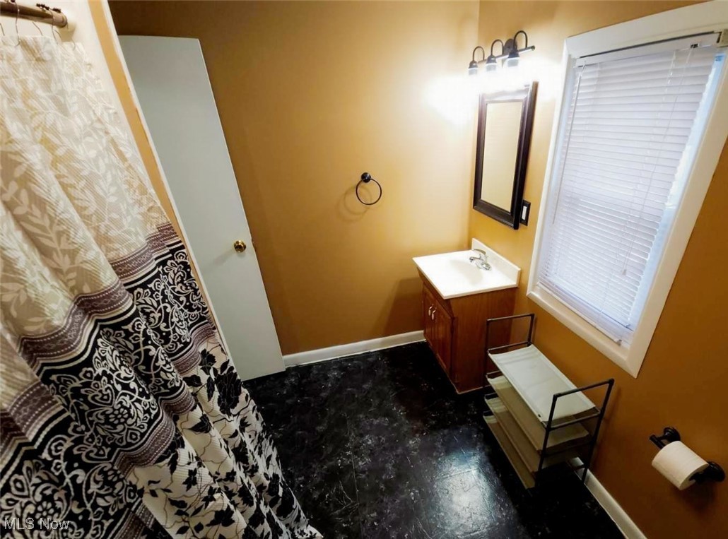 30 Medina Street Rittman, OH 44270 - Photo 13 of 28 Full bathroom featuring vanity and a shower with curtain