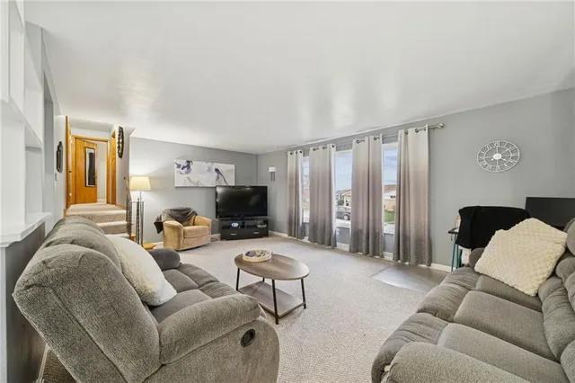 a view of a dining room with furniture and a chandelier
