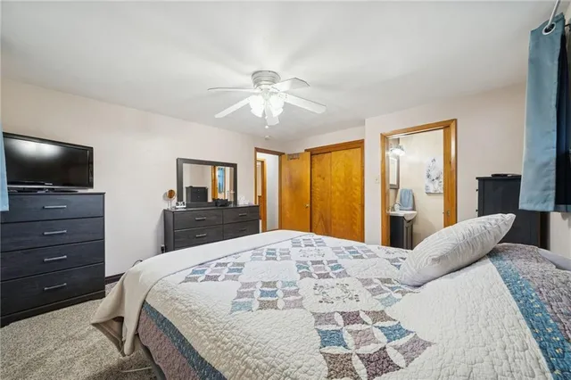 a spacious bedroom with a bed and dresser with mirror