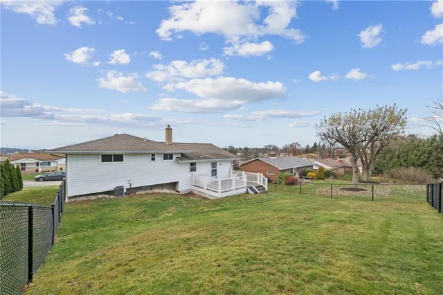 an aerial view of a house with a yard and a fountain