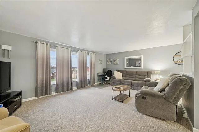 a living room with furniture a couch and a flat screen tv