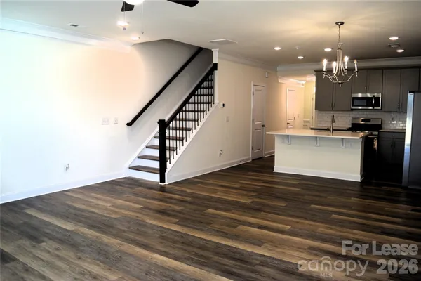 a view of a kitchen with cabinets and wooden floor