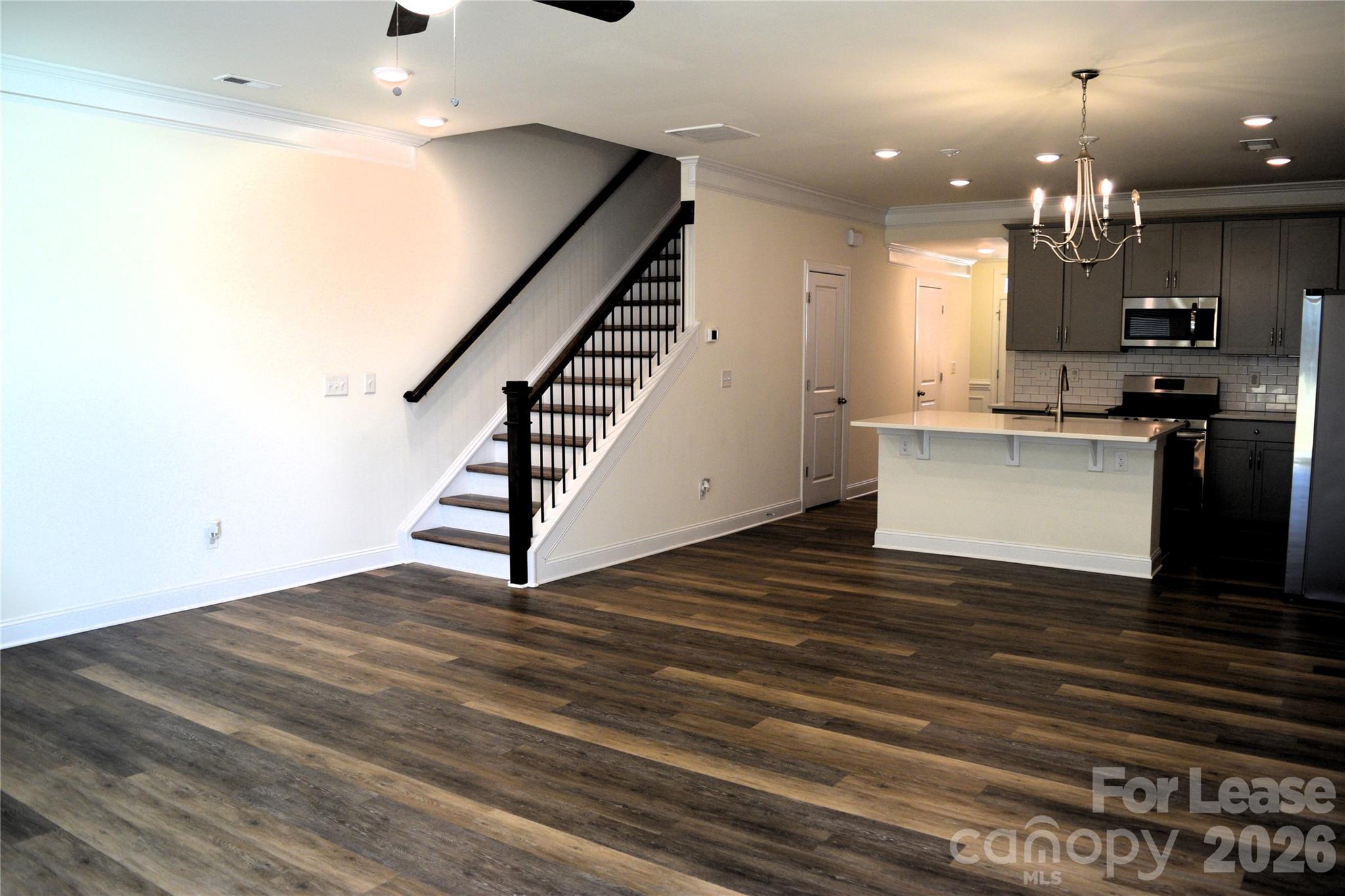 4011 Rothwood Lane Harrisburg, NC 28075 - Photo 11 of 29 a view of a kitchen with cabinets and wooden floor