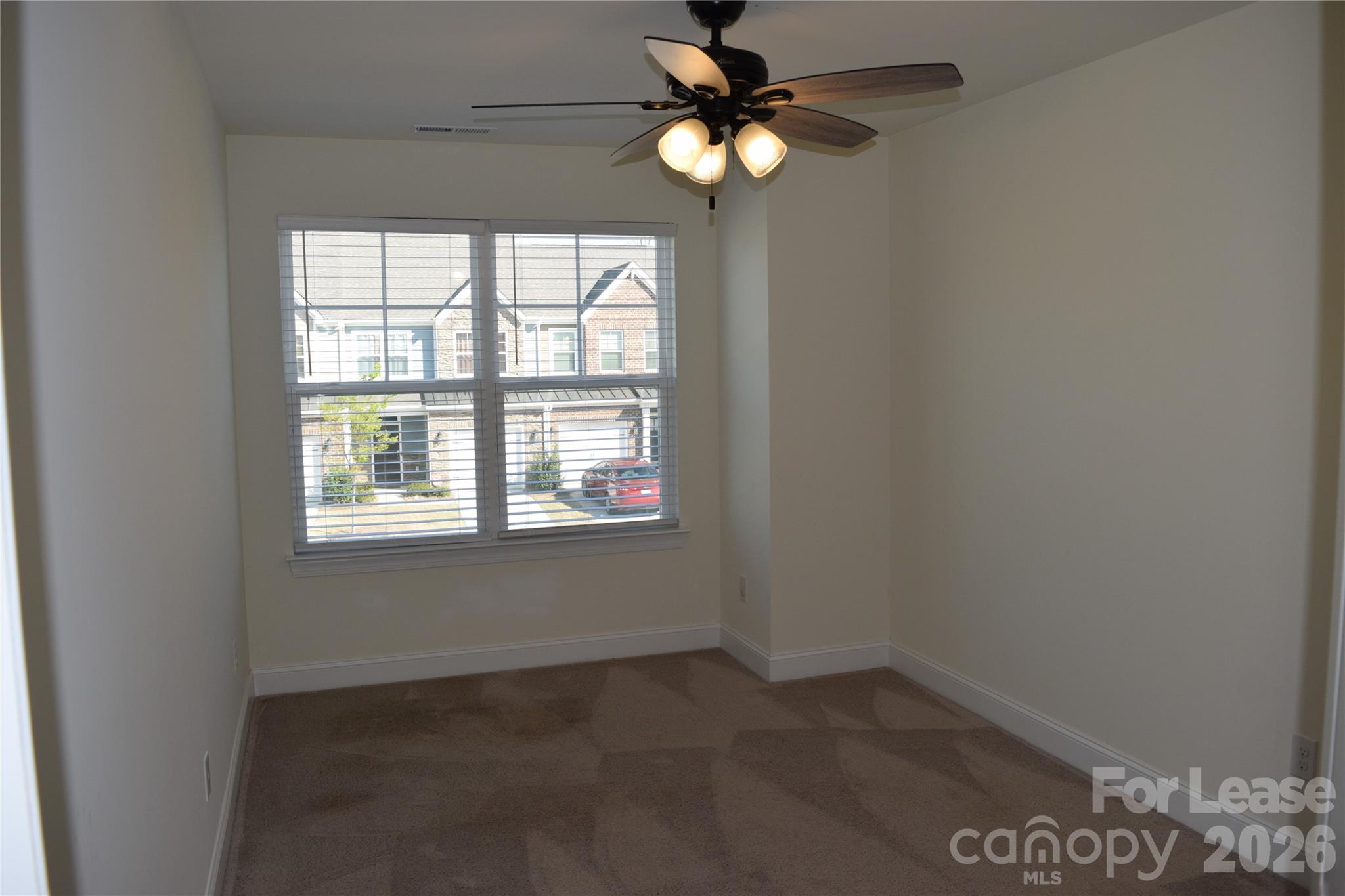 4011 Rothwood Lane Harrisburg, NC 28075 - Photo 19 of 29 an empty room with a window and a fan