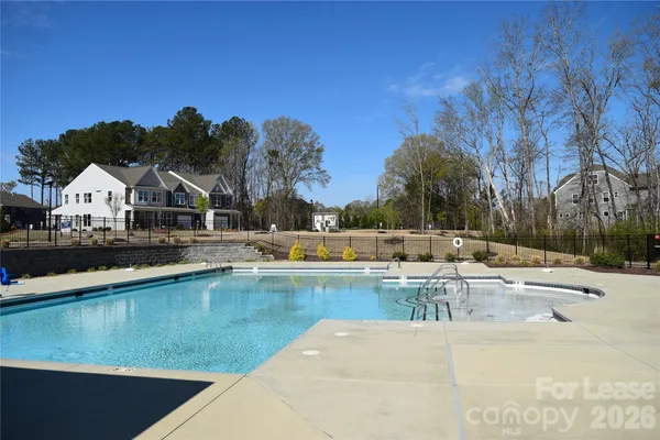a view of a swimming pool with outdoor seating