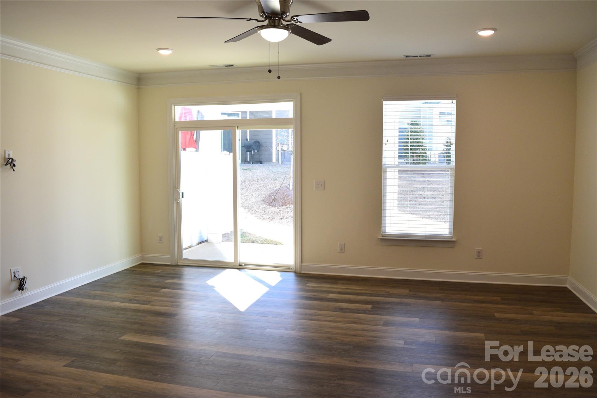 4011 Rothwood Lane Harrisburg, NC 28075 - Photo 9 of 29 an empty room with wooden floor and windows