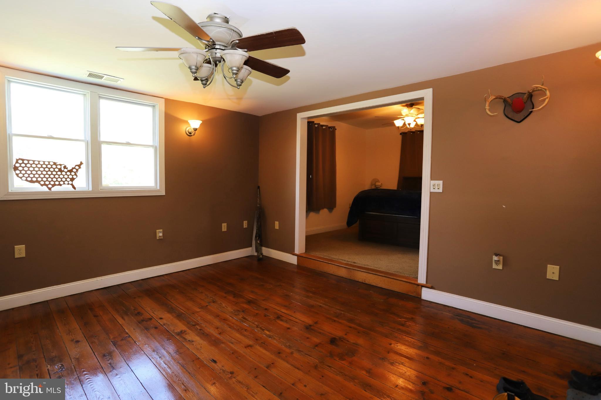 23202 Village Road Unionville, VA 22567 - Photo 13 of 28 a view of workspace with wooden floor and fan