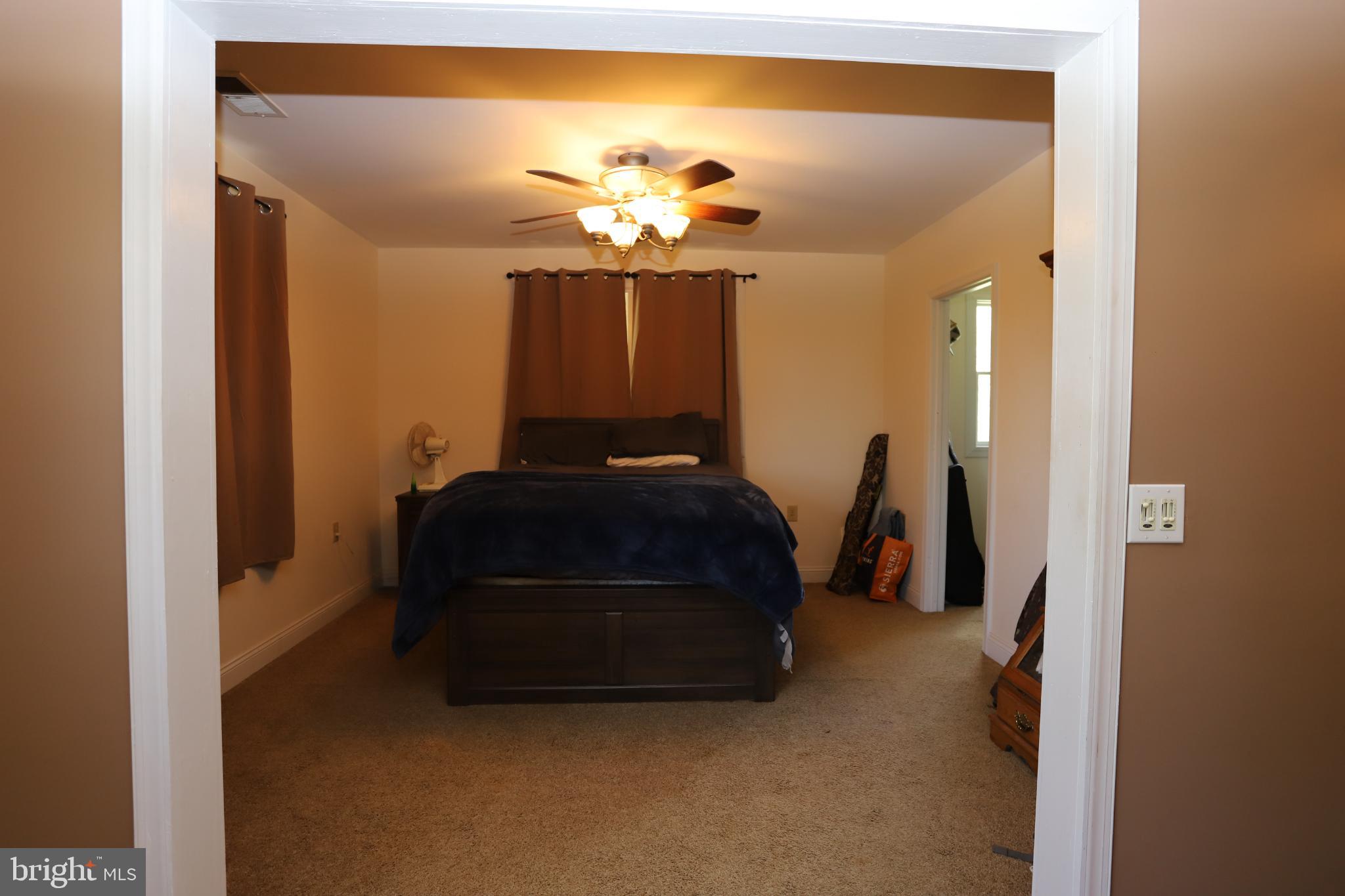 23202 Village Road Unionville, VA 22567 - Photo 14 of 28 a living room with furniture and a chandelier