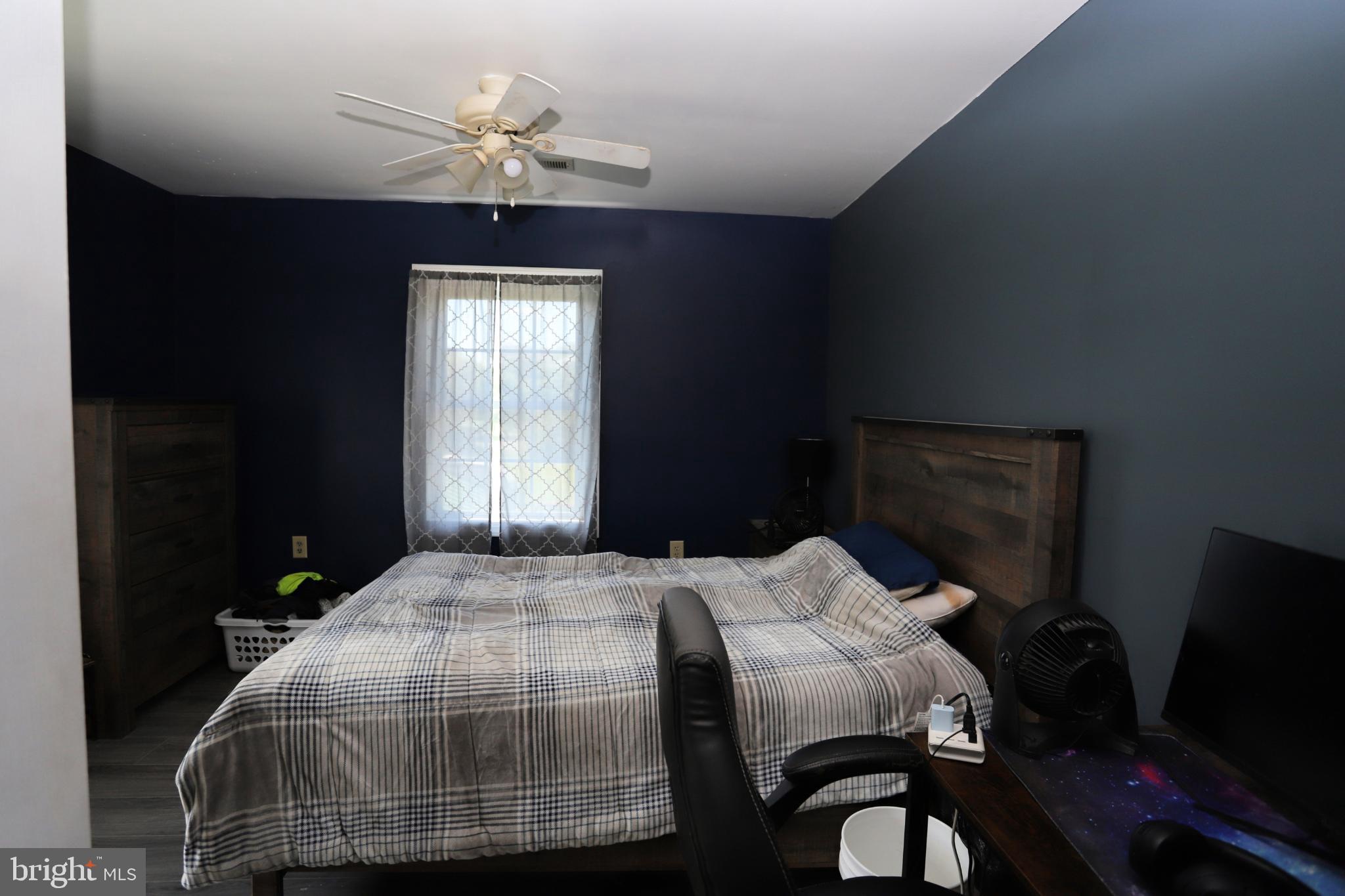 23202 Village Road Unionville, VA 22567 - Photo 16 of 28 a bedroom with a bed and a chandelier