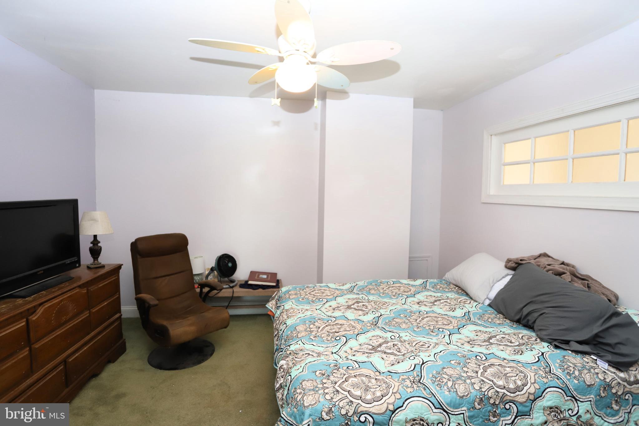 23202 Village Road Unionville, VA 22567 - Photo 18 of 28 a bedroom with a bed and a chair