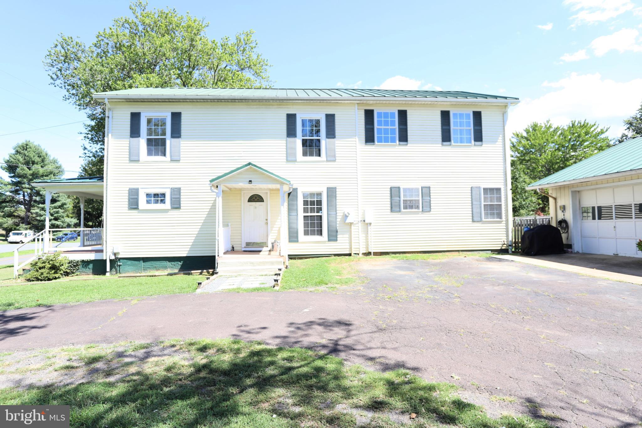 23202 Village Road Unionville, VA 22567 - Photo 25 of 28 a front view of a house with a yard and garage