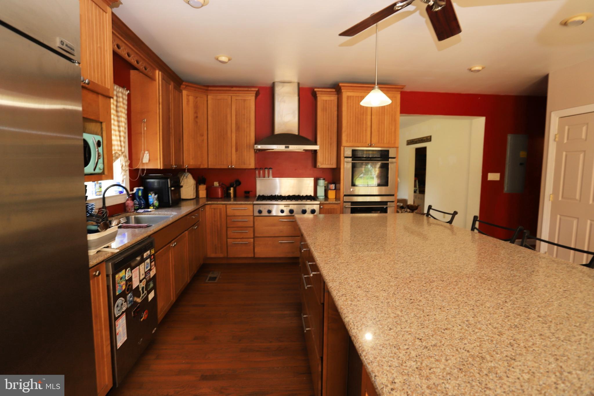 23202 Village Road Unionville, VA 22567 - Photo 7 of 28 a kitchen with counter top space a sink a window and stainless steel appliances
