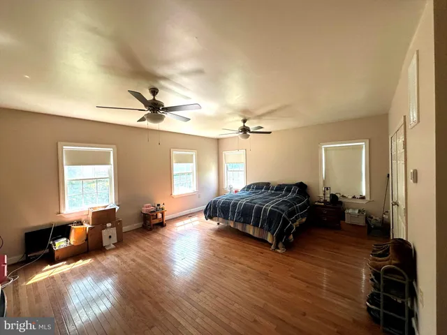 a bedroom with furniture and a wooden floor