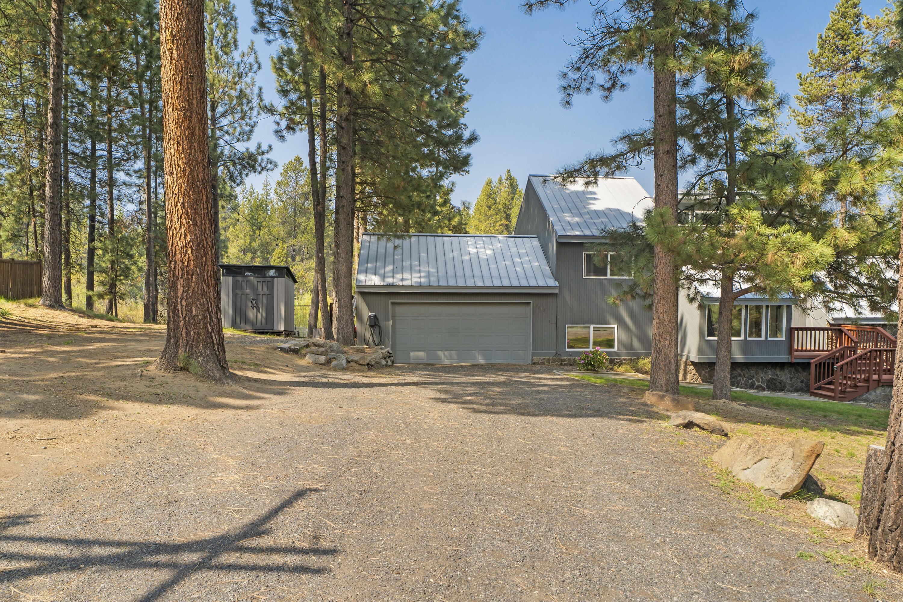 17062 Milky Way Bend, OR 97707 - Photo 34 of 39 Detached two-car garage tucked into the ponderosa pines with EV charger