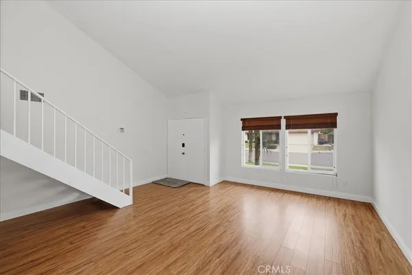 a view of a room with wooden floor and stairs