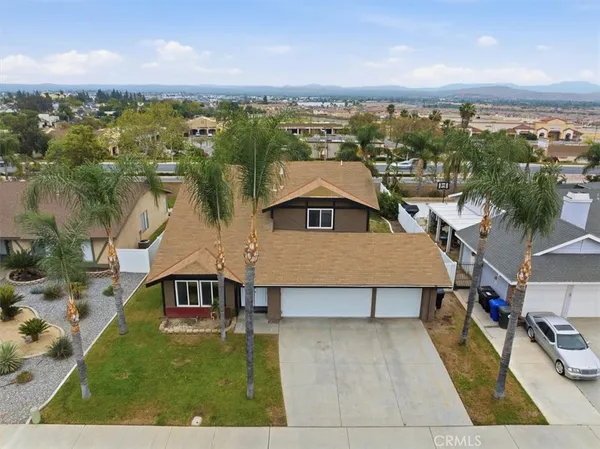 an aerial view of a house with a yard and lake view