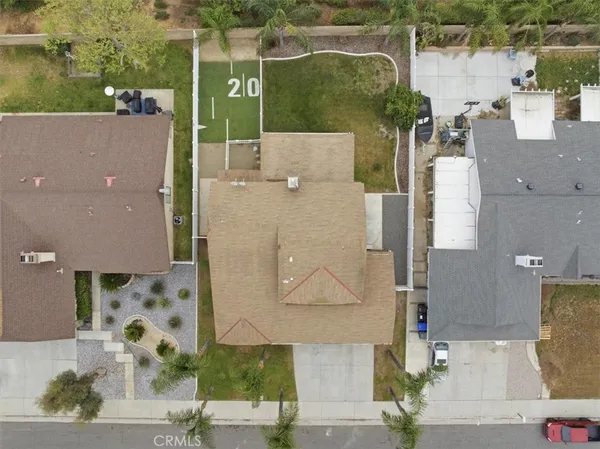 an aerial view of residential houses with outdoor space and parking