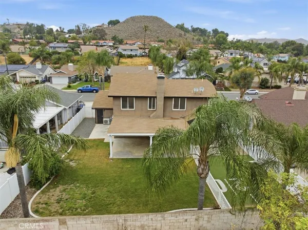 a front view of a house with a yard and potted plants
