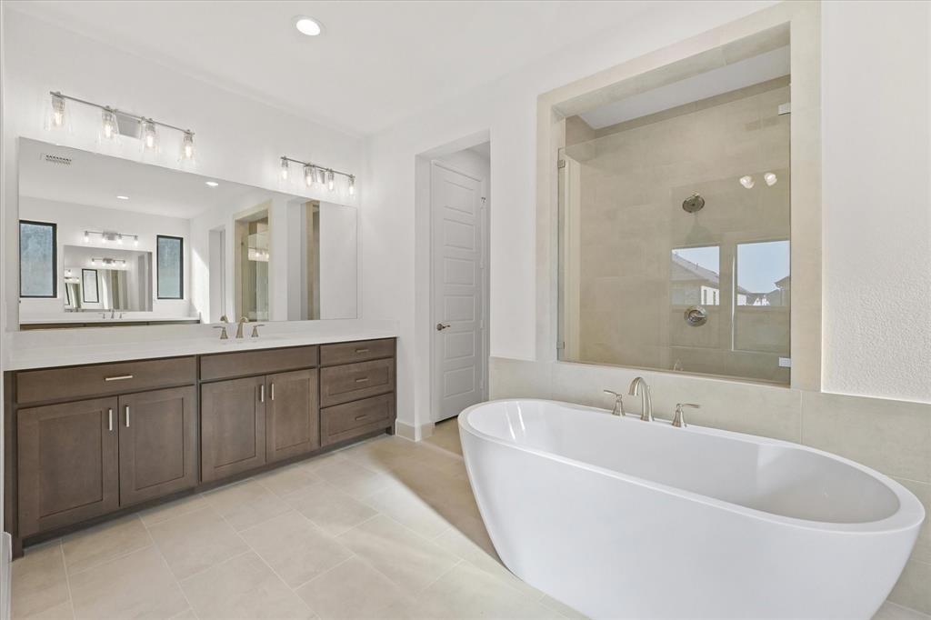 4626 Rillstone Road Midlothian, TX 76065 - Photo 16 of 40 Full bathroom featuring a freestanding bath, vanity, a shower stall, light tile patterned floors, and recessed lighting
