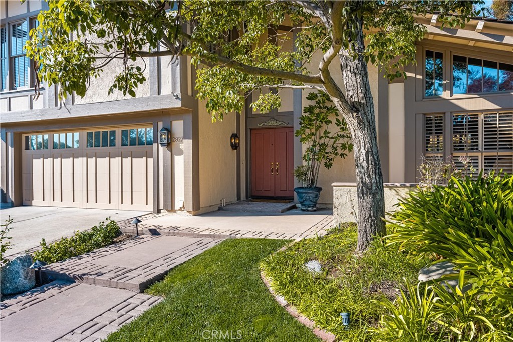 2927 Treeview Place Fullerton, CA 92835 - Photo 2 of 62 a front view of a house with a yard outdoor seating and garage