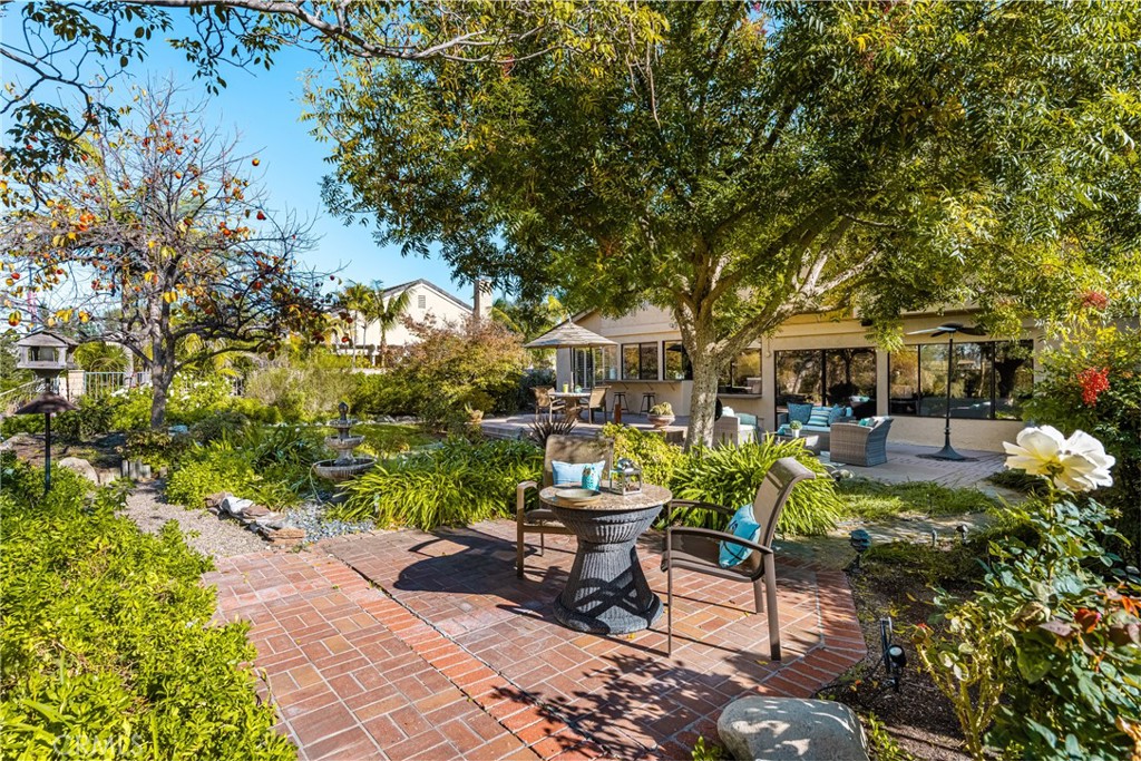 2927 Treeview Place Fullerton, CA 92835 - Photo 36 of 62 a view of a patio with table and chairs potted plants and large tree