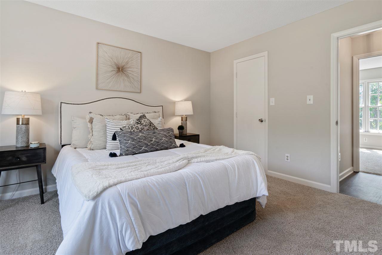 3324 Castlegate Drive Raleigh, NC 27616 - Photo 14 of 26 a bedroom with a bed and a painting on the wall