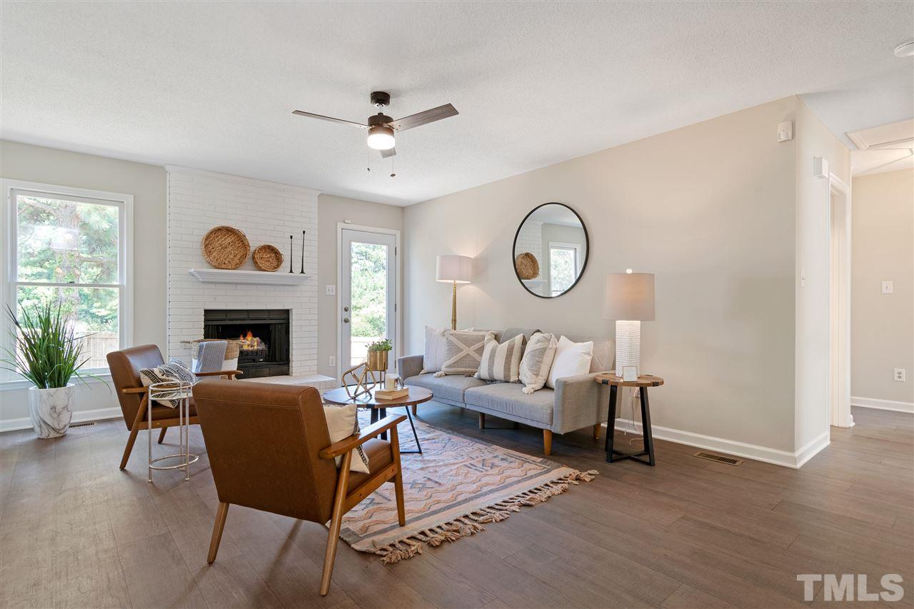 3324 Castlegate Drive Raleigh, NC 27616 - Photo 4 of 26 a living room with furniture and a fireplace