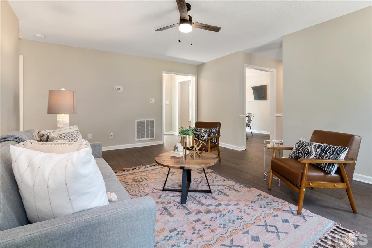 3324 Castlegate Drive Raleigh, NC 27616 - Photo 5 of 26 a living room with furniture and a table